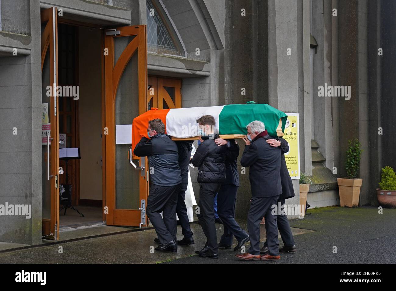 The coffin of Austin Currie is carried into the Church of the