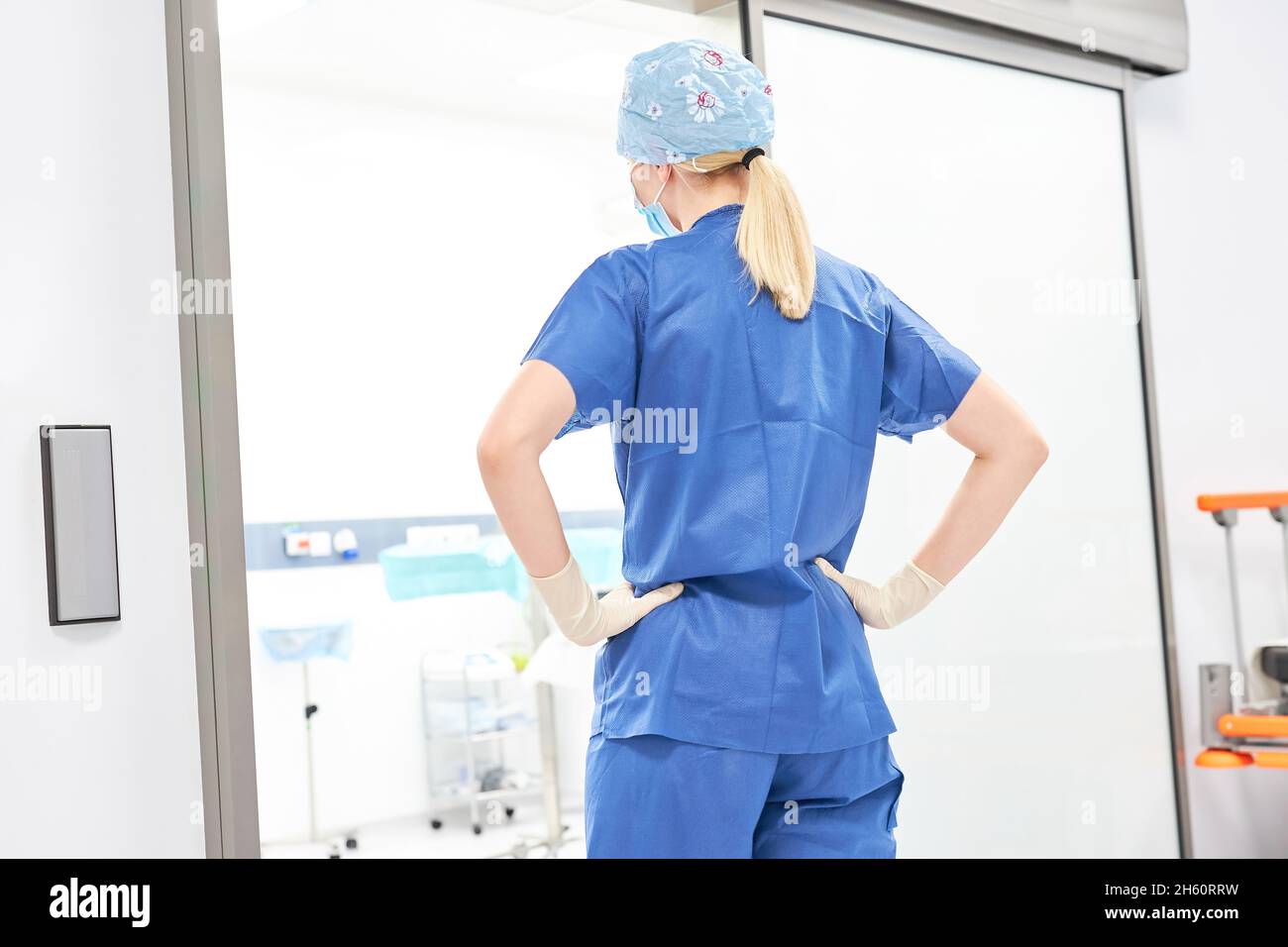 When changing shifts, the nurse or doctor stands tense in front of the intensive care unit of the clinic Stock Photo