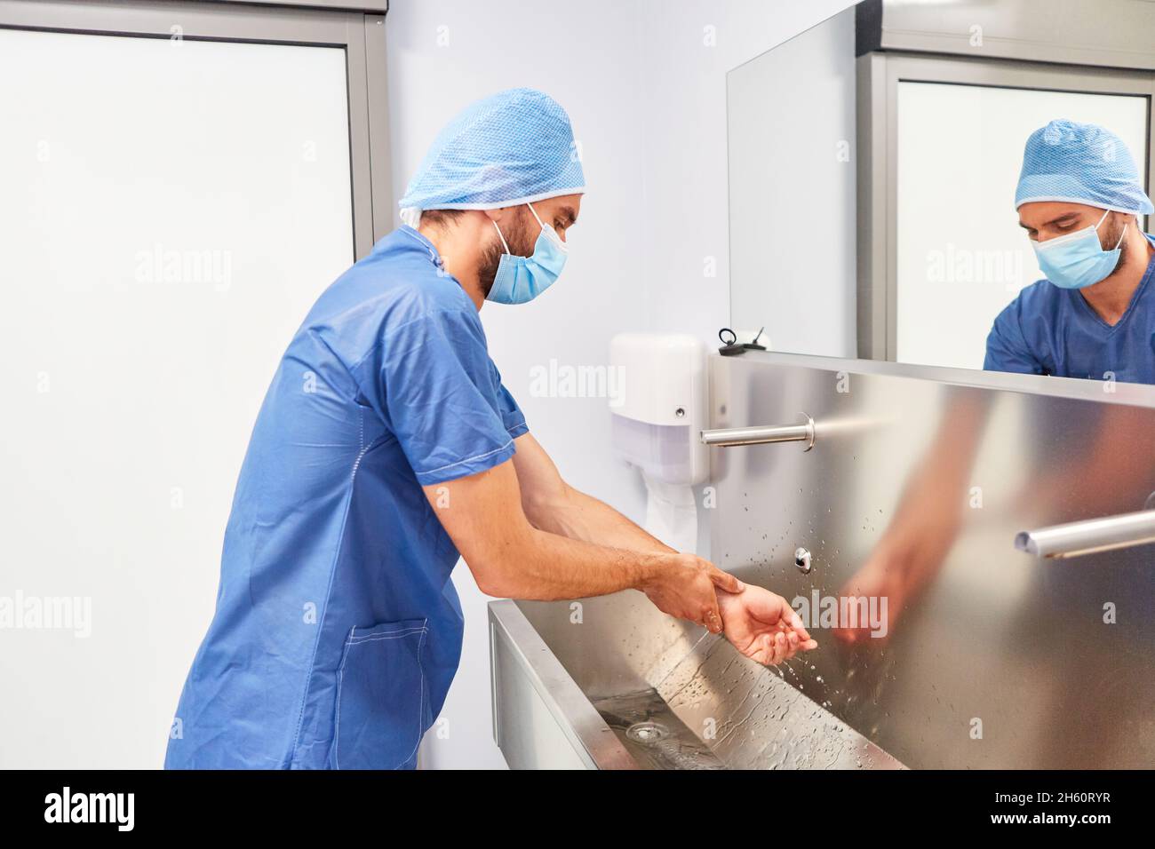 Surgeon or nurse during surgical hand washing as disinfection before an