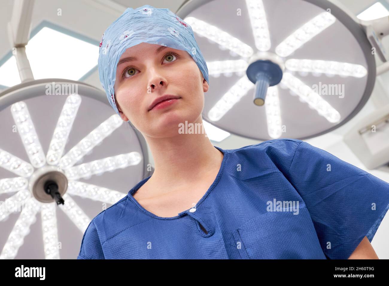 Young woman as a surgical nurse in training or a doctor in an internship in the operating theater Stock Photo