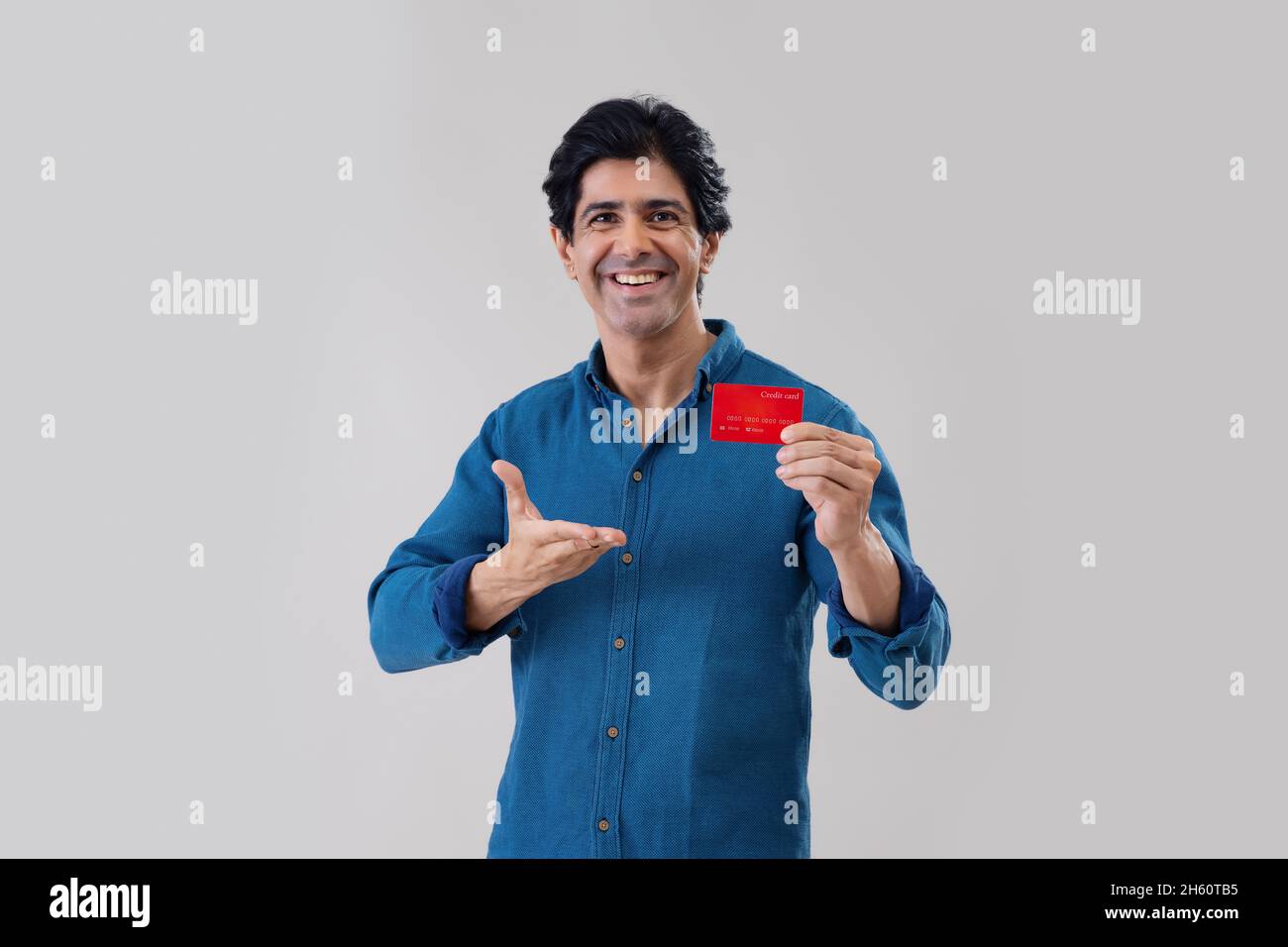 Indian man posing in front of camera with credit card Stock Photo - Alamy