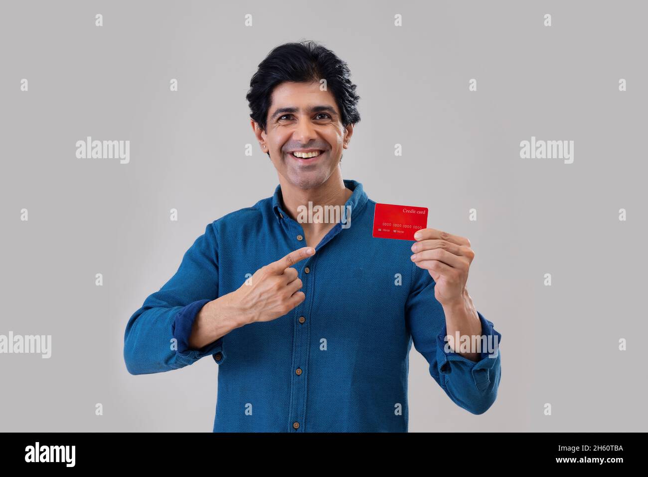 Indian man posing in front of camera with credit card Stock Photo - Alamy