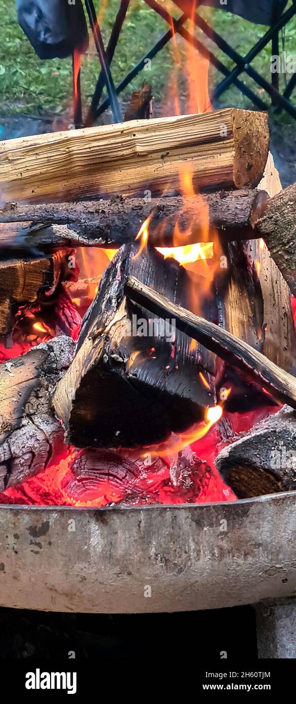 Feuerschale mit berennendem Holz sowie Glut Stock Photo