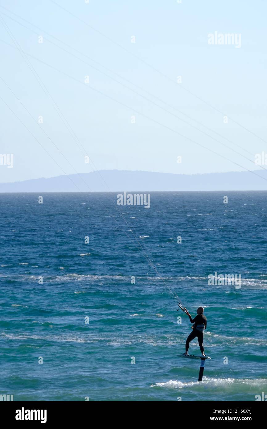 Lone surfer kite surfing with hydrofoil in the water off Los Lances beach.Tarifa, Costa de la Luz, Cadiz province, Andalucia, Spain Stock Photo