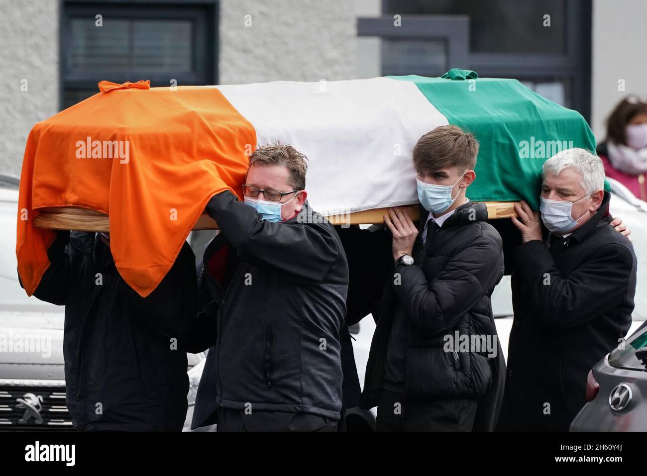 The coffin of Austin Currie is carried into the Church of the