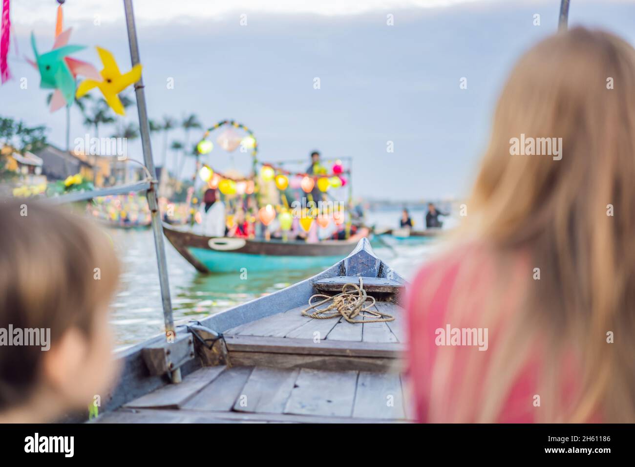 Happy woman traveler ride a national boat on background of Hoi An ...