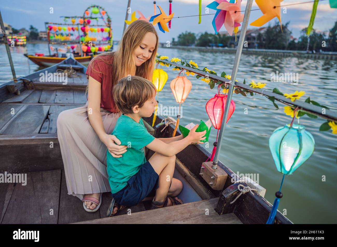 Happy family Mother and son of travelers ride a national boat on ...