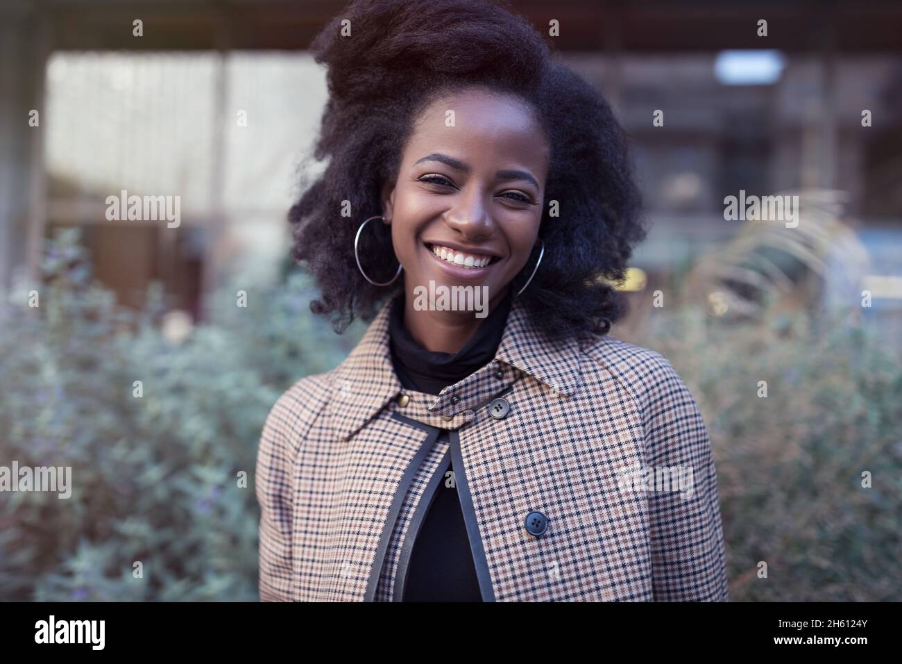 Beautiful african american young woman with afro and large hoop ...