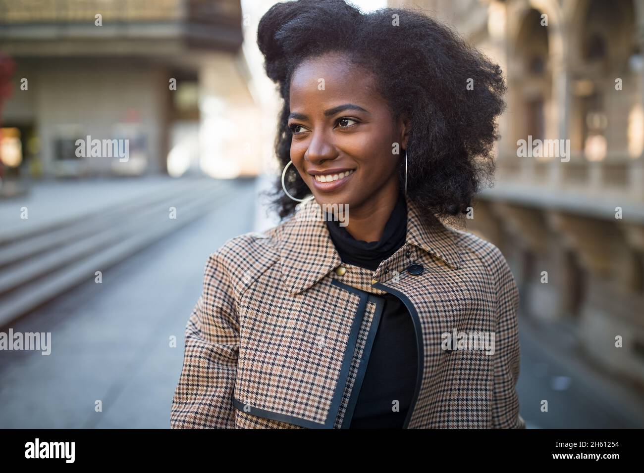 Beautiful African American young woman with afro and large hoop ...