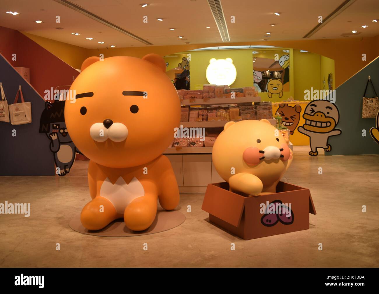 Large models of Kakao Freinds, Ryan and Choonsik are  on a shop floor with other characters cheering on background, Hong Kong Stock Photo