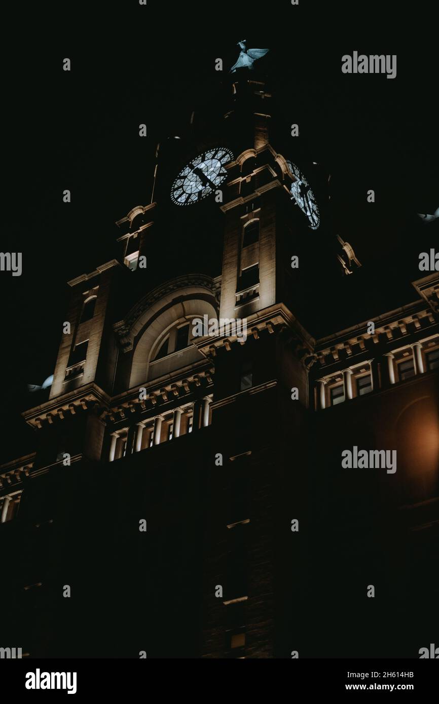 Vertical low angle shot of the clock tower at night Stock Photo - Alamy