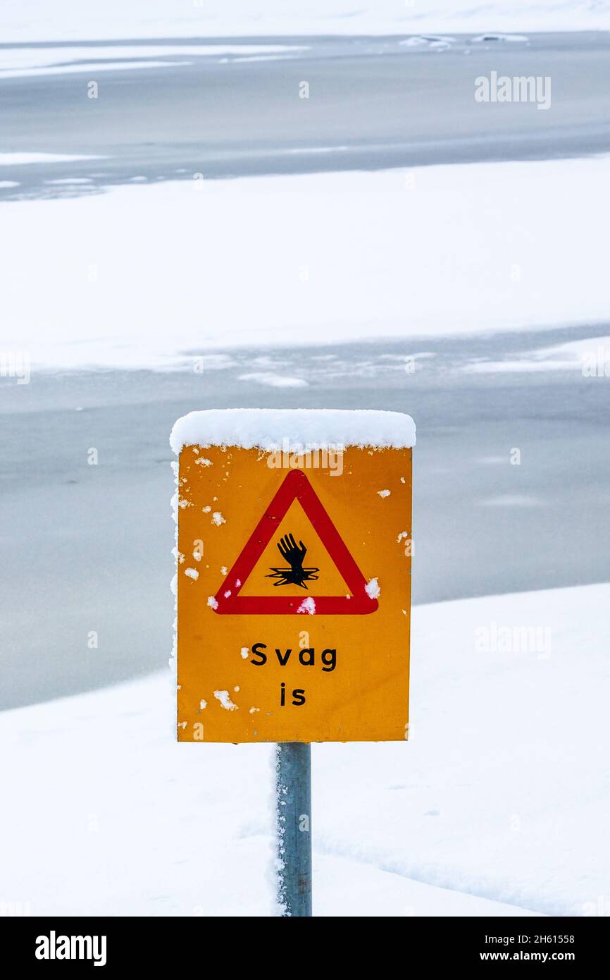 Thin ice warning sign by a lake Stock Photo