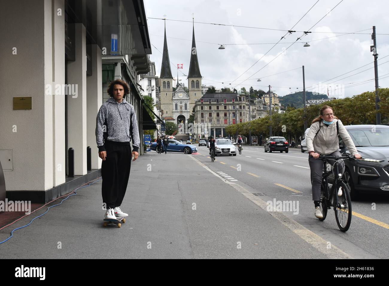 Young man skate boarding on pavement Lucerne, Switzerland Stock Photo