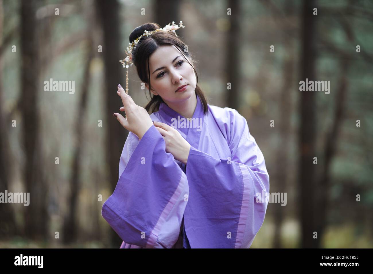 A nonChinese woman posing against the backdrop of an autumn forest