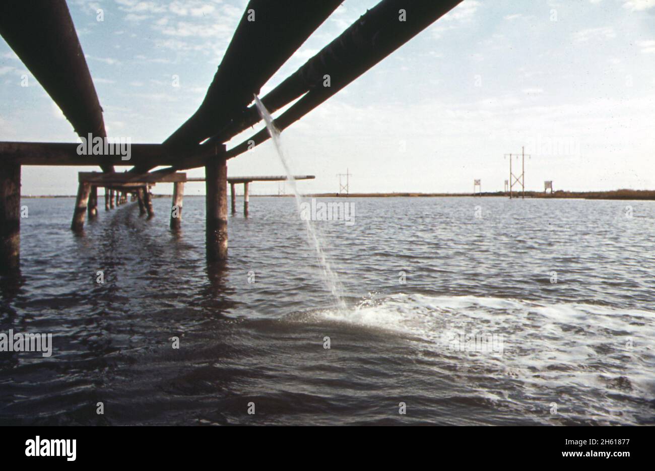 Leak in pipeline that carries mined sulphur from Lake Grande Ecaille mine to port sulphur on the Mississippi River. The Freeport Sulphur Company Pipeline canal; Louisiana  ca. December 1972 Stock Photo