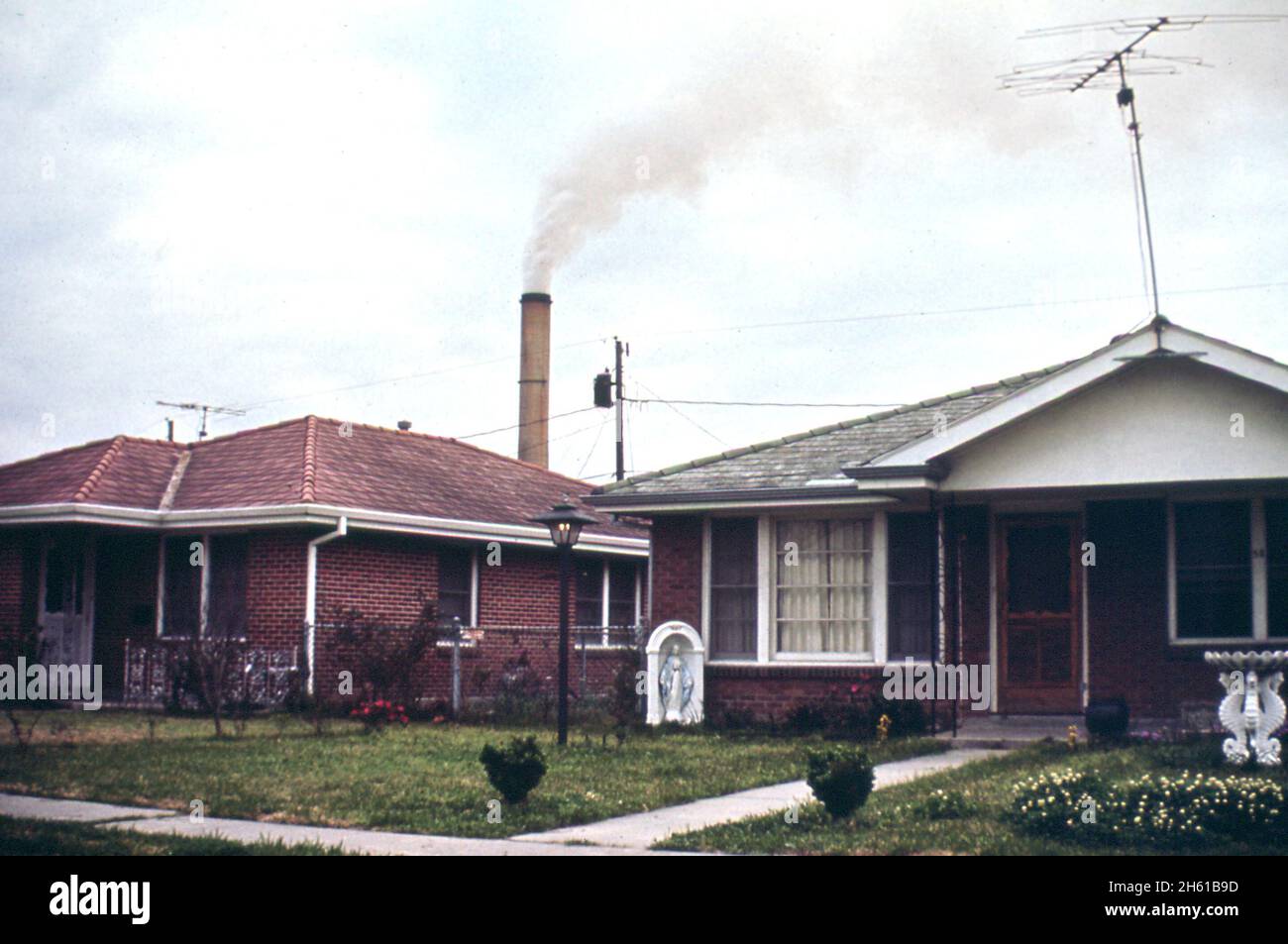 The Kaiser Aluminum plant smokestack in background spreads fumes over