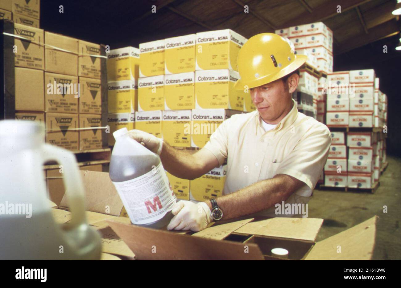 An environmental protection agency inspector examines a container of