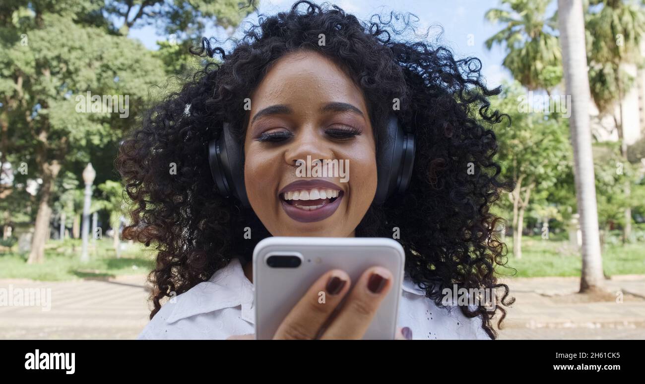 Afro young woman walking using hi-res stock photography and images - Alamy