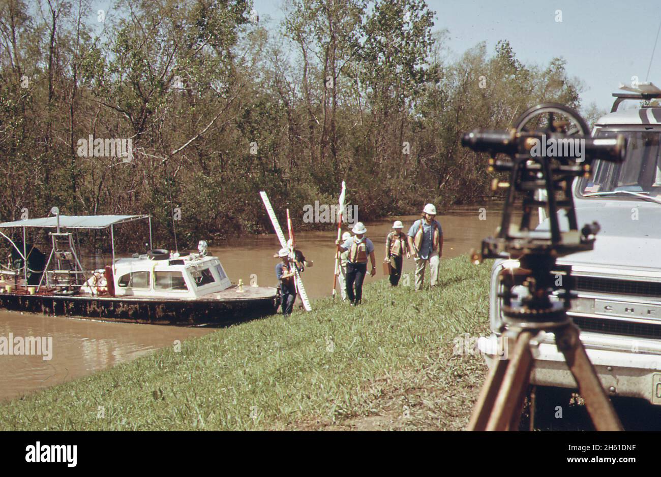 Survey team of U.S. Army corps of engineers on Mississippi River levee at Montz. Heavy erosion indicates need for construction of a setback levee; Louisiana  ca. March 1973 Stock Photo