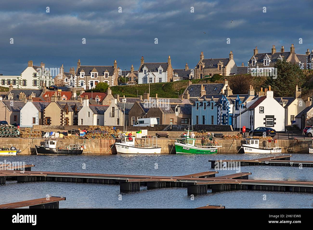 FINDOCHTY MORAY COAST SCOTLAND THE NEW PONTOONS AND SMALL FISHING BOATS MOORED ALONGSIDE THE HARBOUR WALL Stock Photo