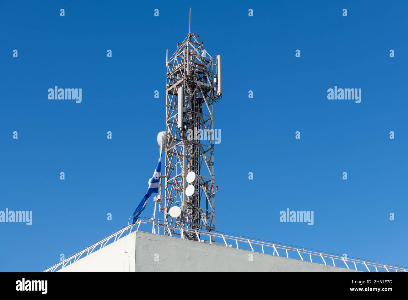 A wifi transmission mast on the rooftop of a building. Stock Photo