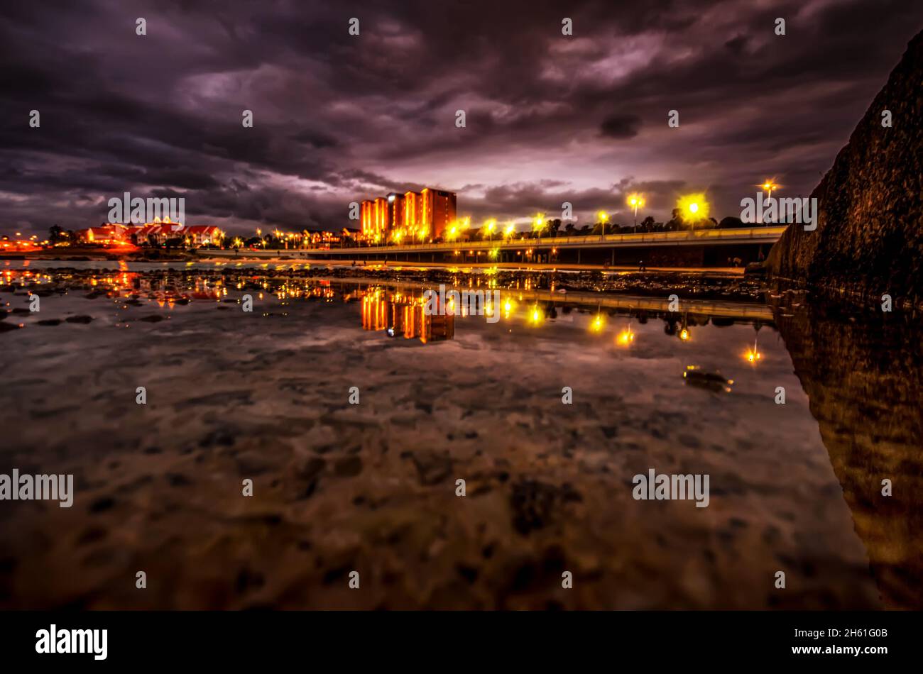 View of the night city reflection on the water surface Stock Photo - Alamy