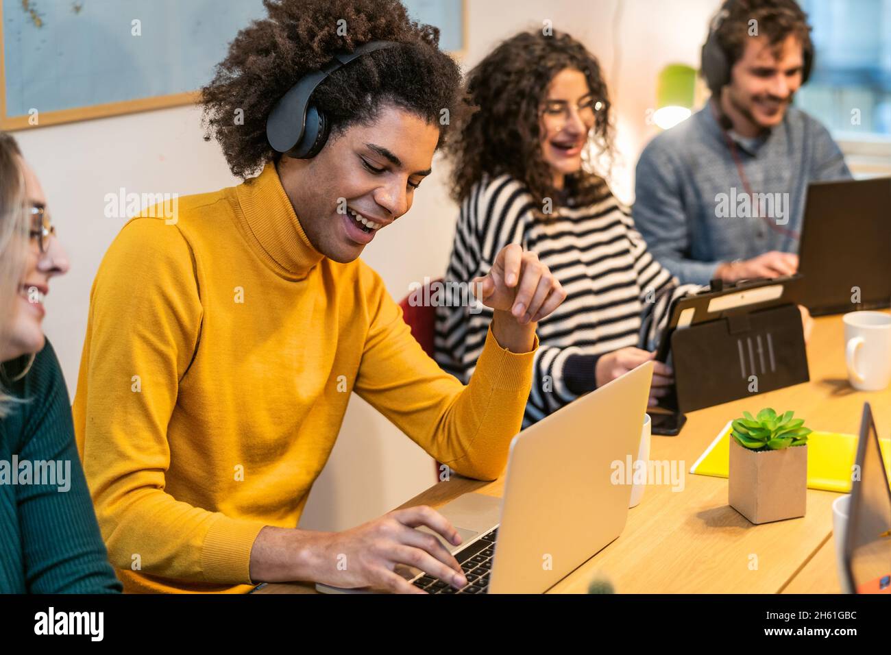 Young people in co-working creative space - Youth millennial generation and business technology concept Stock Photo