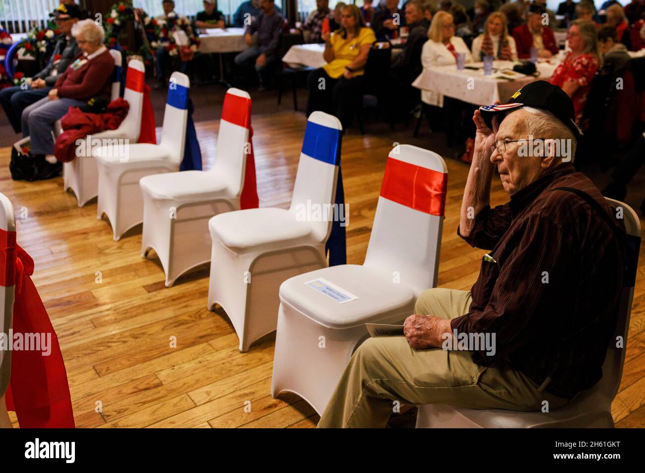 BLOOMINGTON, UNITED STATES - 2021/11/11: World War II veteran Herbert Ray, who served on the USS YMS 17 with the US Navy in the Philippines in 1945 sits in a nearly empty section for WWII and Korean War veterans during a Veterans Day Ceremony at the Burton Woolery American Legion Post 18, Thursday, November 11, 2021 in Bloomington, Ind. The names of 129 local veterans who have died since November 2020 were read during the ceremony. (Photo by Jeremy Hogan/The Bloomingtonian) Stock Photo