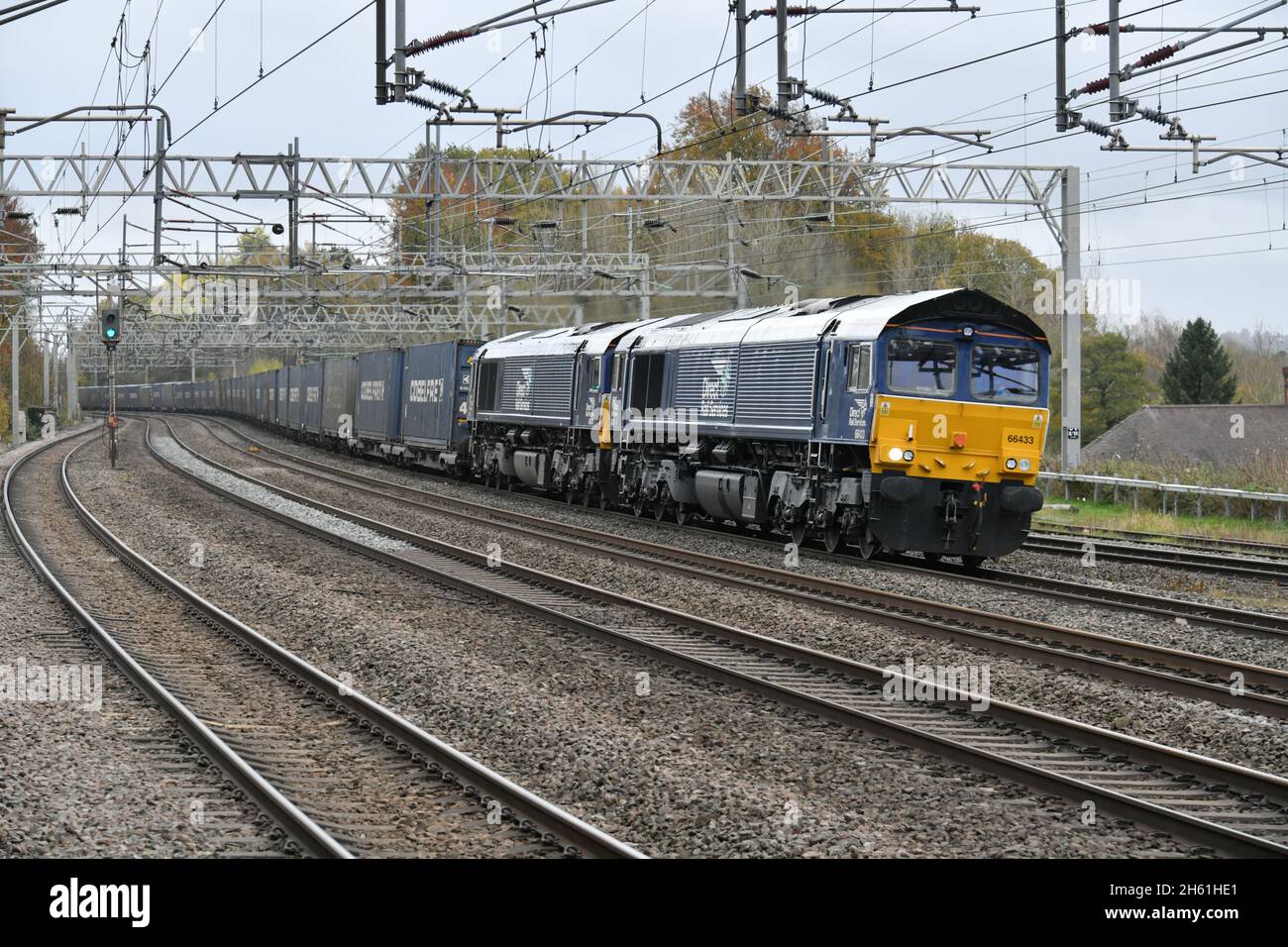 Double headed diesel hauled container train running under the wires on the West Coast Main Line approaching Rugeley Trent Valley on 12 November 2021 Stock Photo