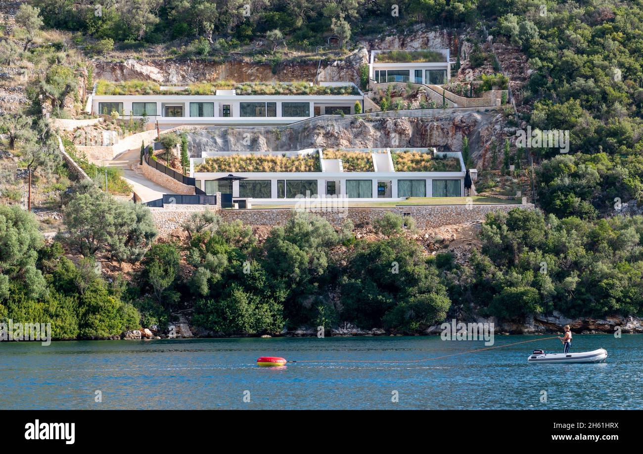 Lefkada. Greece-10.20.2021. A modern architectural villa design development on the hill side seafront of Syvota. A busy sailing holiday resort. Stock Photo