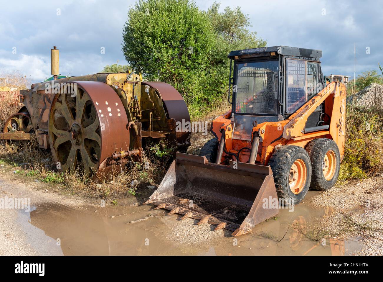 Old construction heavy machinery on a building site. Stock Photo