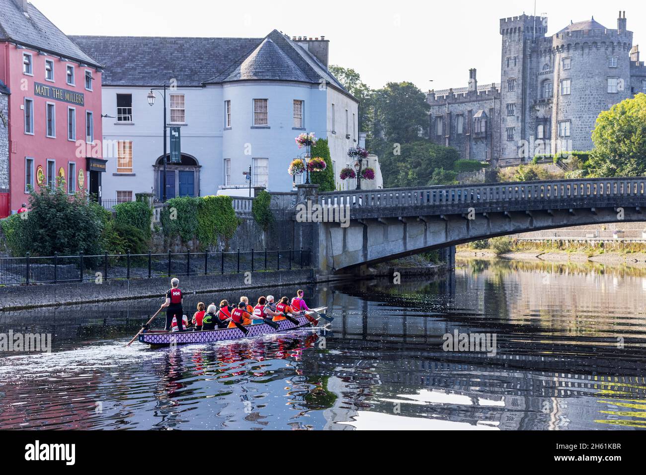 Dragon boat womens team training in their craft on the river Nore in Kilkenny, County Kilkenny, Ireland Stock Photo