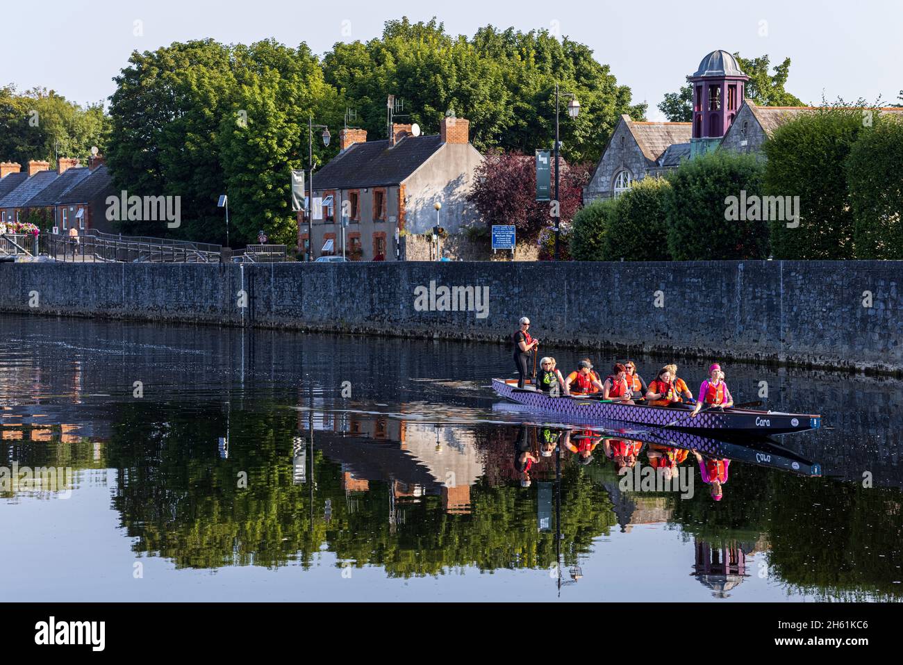 Dragon boat womens team training in their craft on the river Nore in Kilkenny, County Kilkenny, Ireland Stock Photo