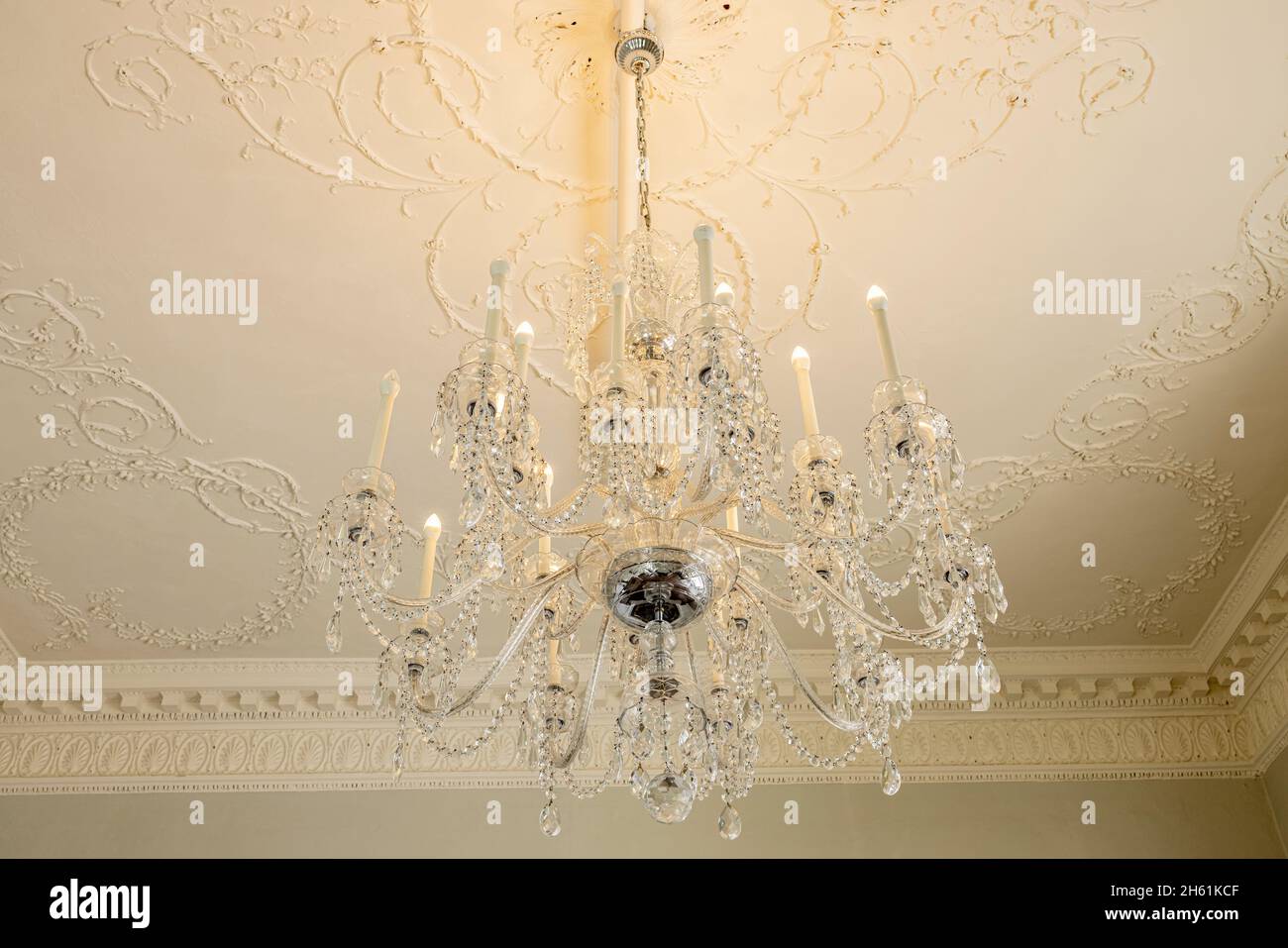 Crystal chandelier with electric light bulbs hanging in Rathfarnham Castle in Dublin, Ireland Stock Photo