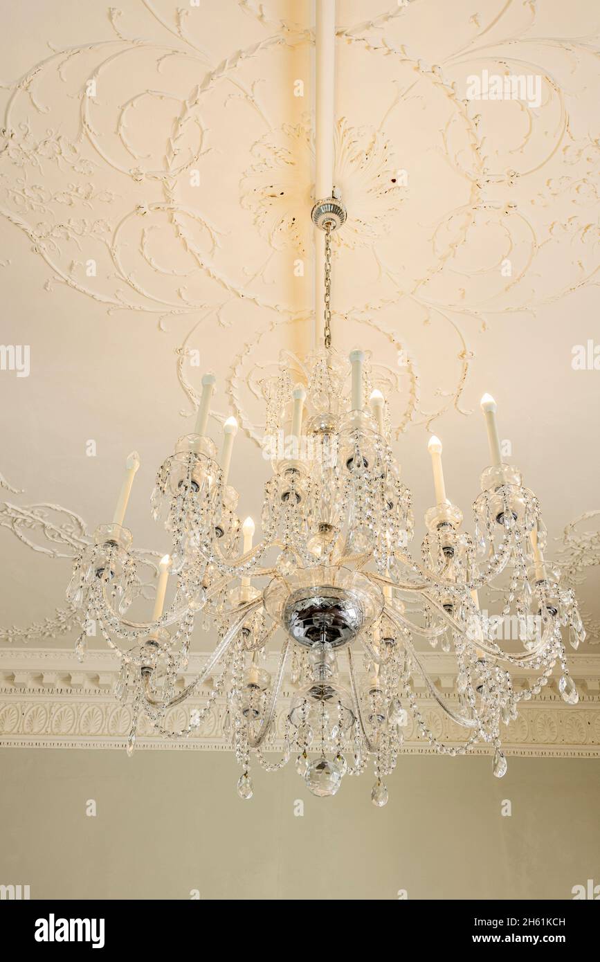 Crystal chandelier with electric light bulbs hanging in Rathfarnham Castle in Dublin, Ireland Stock Photo