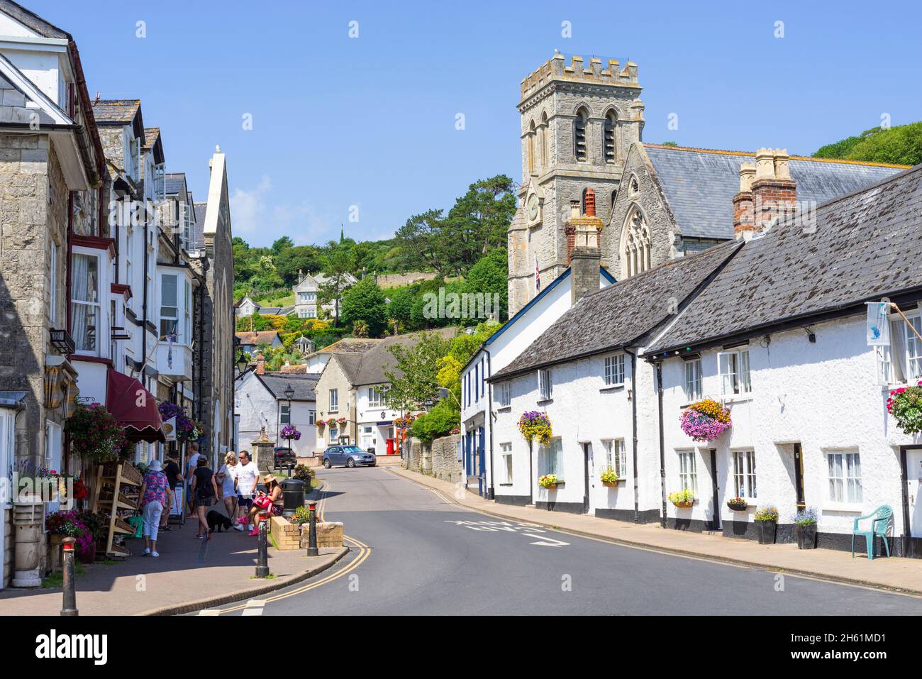 St Michael's Church and other small shops on Fore Street Beer Village centre Devon England UK GB Europe Stock Photo