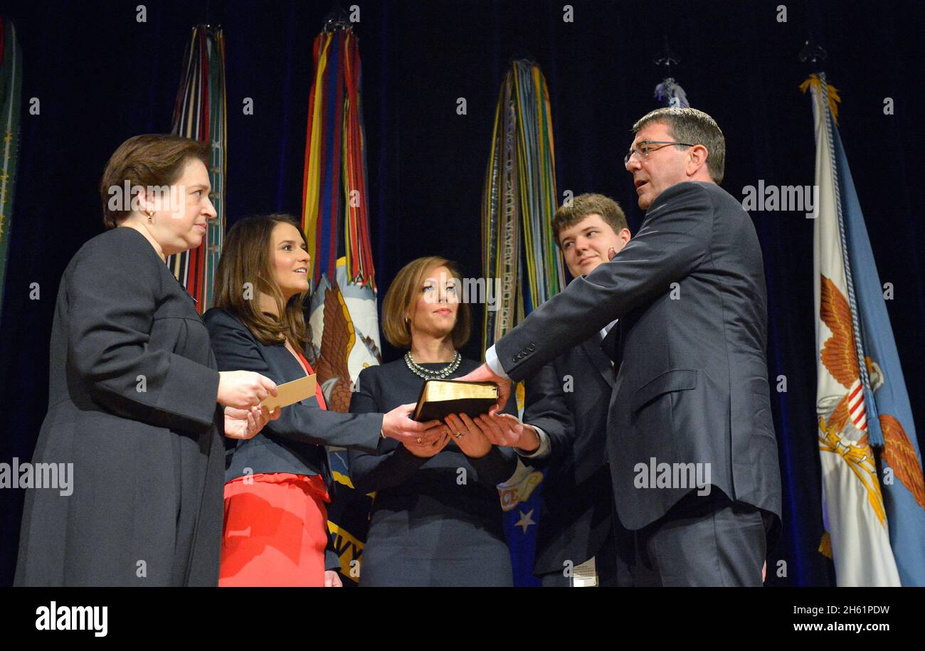Associate Justice Elena Kagan administers the oath of office to Secretary of Defense Ash Carter during a ceremonial swearing in held in the Pentagon Auditorium, March 6, 2015. Stock Photo