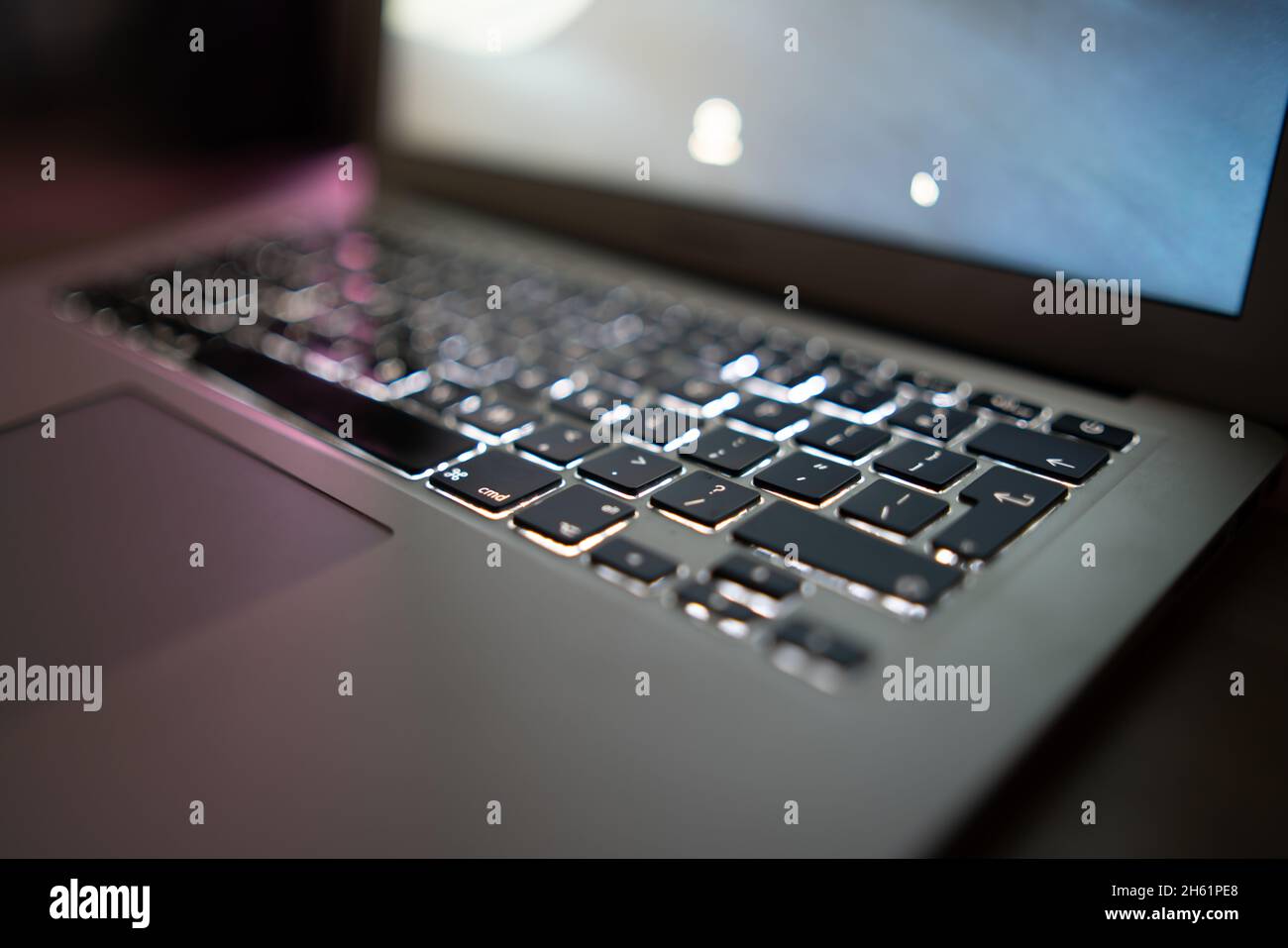 Close up of laptop keyboard colorful neon illumination, backlit keyboard. Stock Photo