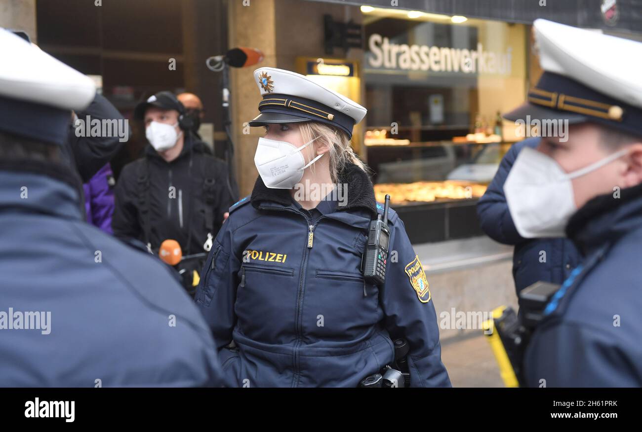 Munich, Germany. 12th Nov, 2021. Police officers stand in front of a restaurant during a press event on Corona controls in Munich. During the controls of the tightened Corona regulations, the police in Bavaria discovered several violations. Credit: Felix Hörhager/dpa/Alamy Live News Stock Photo