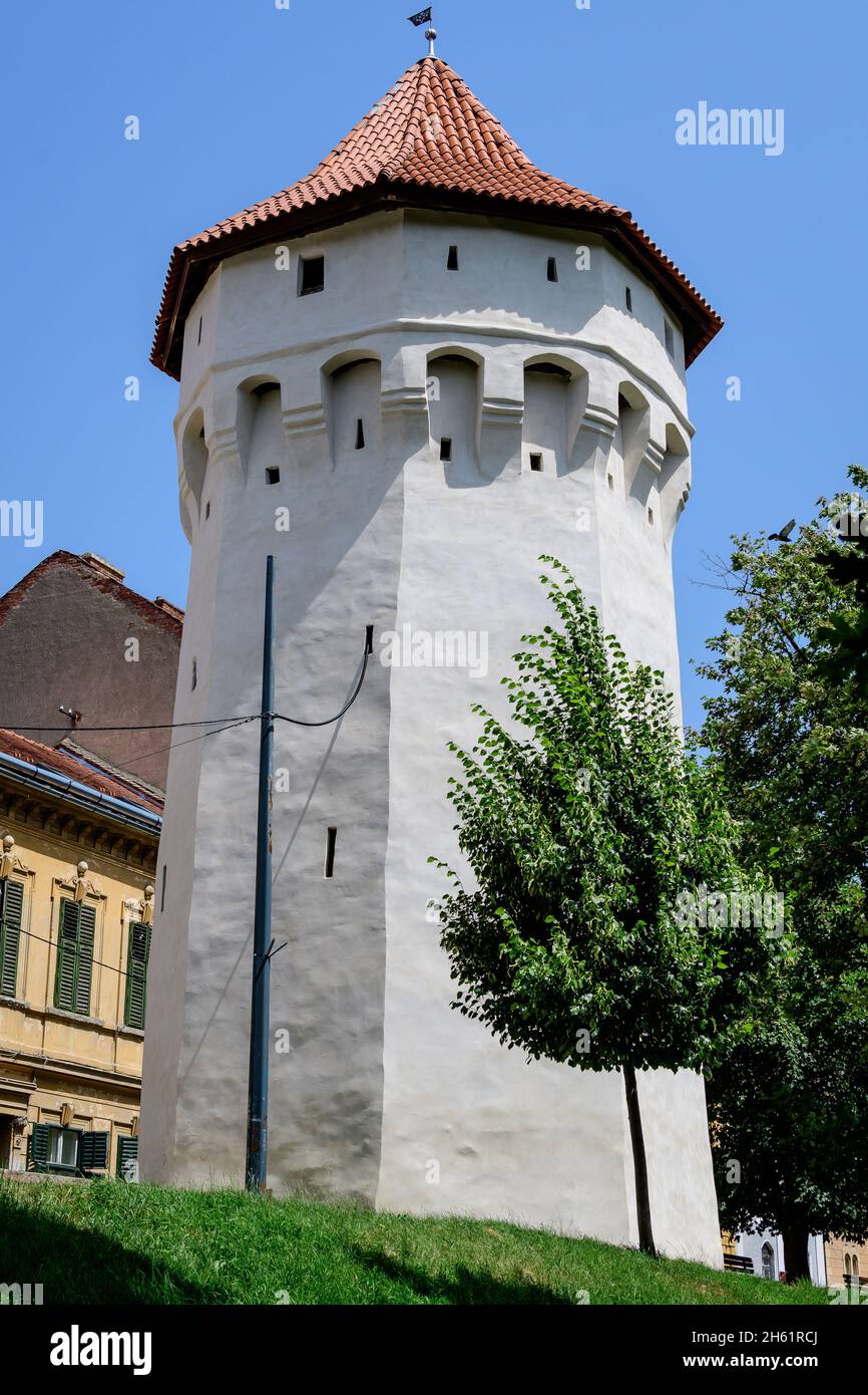 Large old white painted stone tower in the historical center of the Sibiu city, near Citadel Street and Park (Strada si Parcul Cetatii), in Transylvan Stock Photo