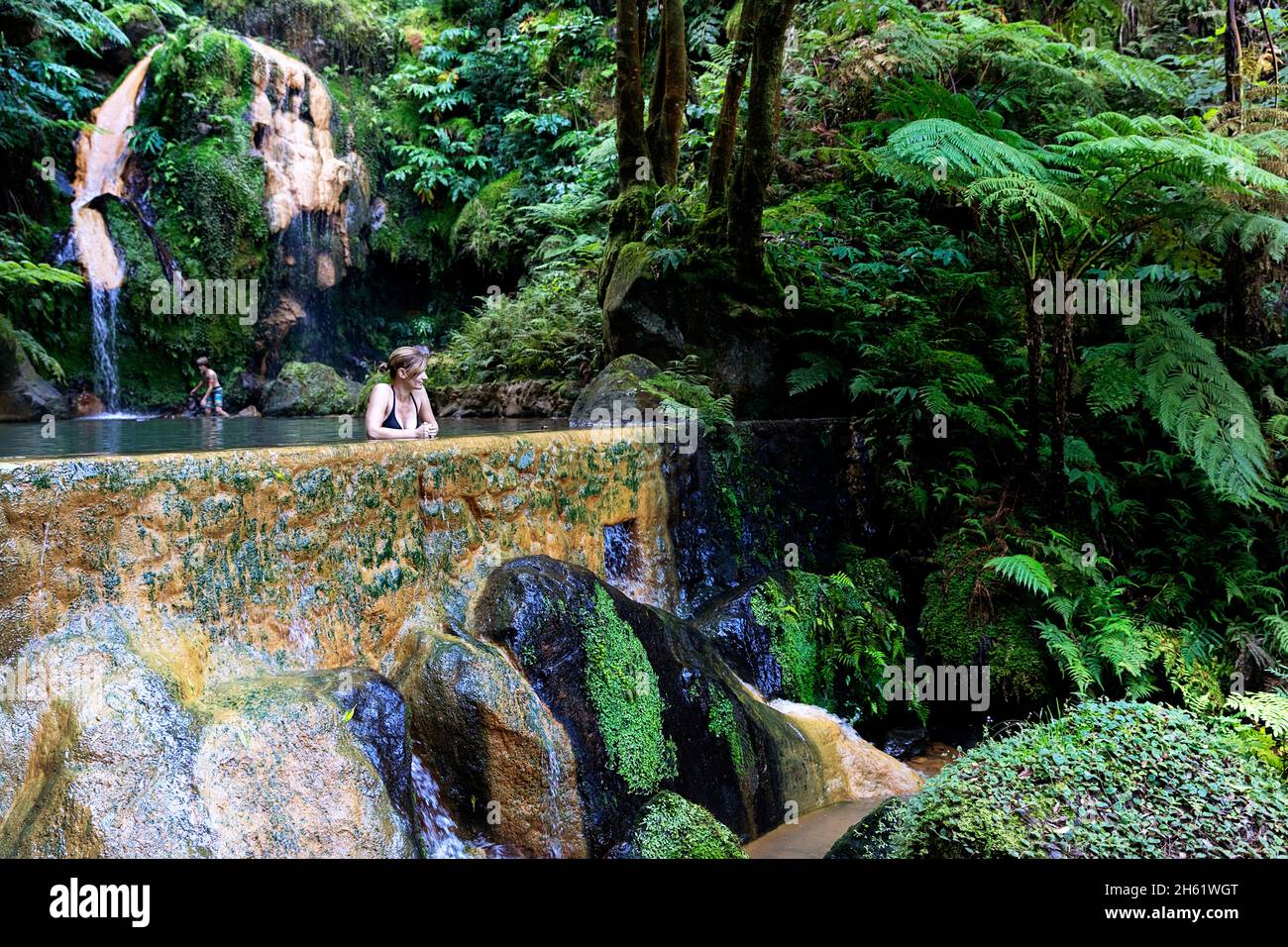 Woman bathing in beautiful thermal pools of Caldeira Velha, Sao Miguel
