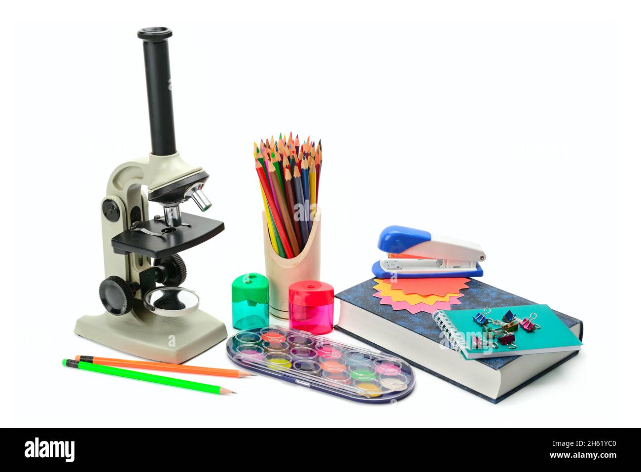 Laboratory microscope, textbook and other school supplies isolated on ...