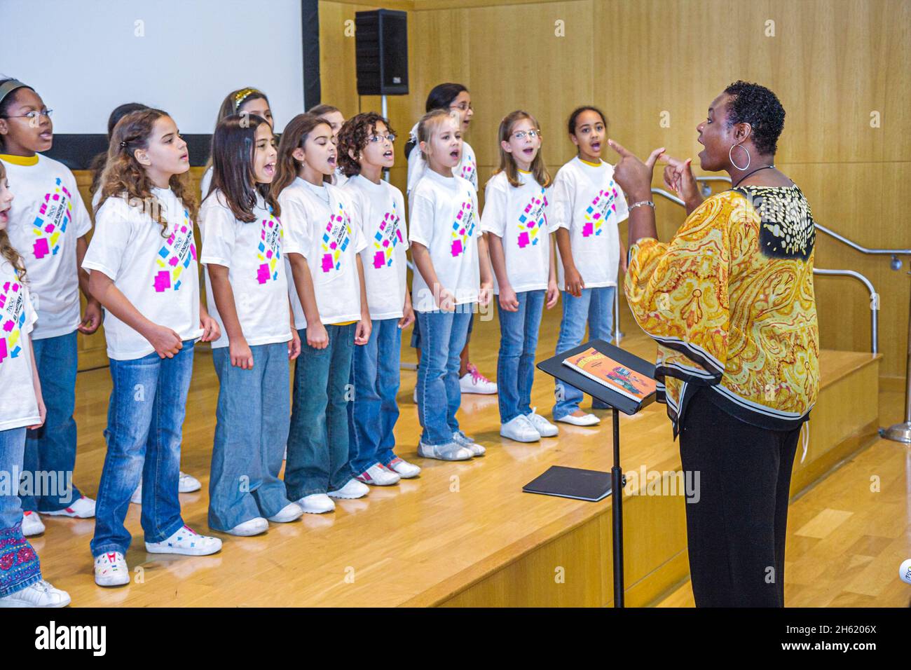 Miami Beach Florida,Public Library,children's chorus,choral director stage Black femal Hispanic girls student students singing performing Stock Photo