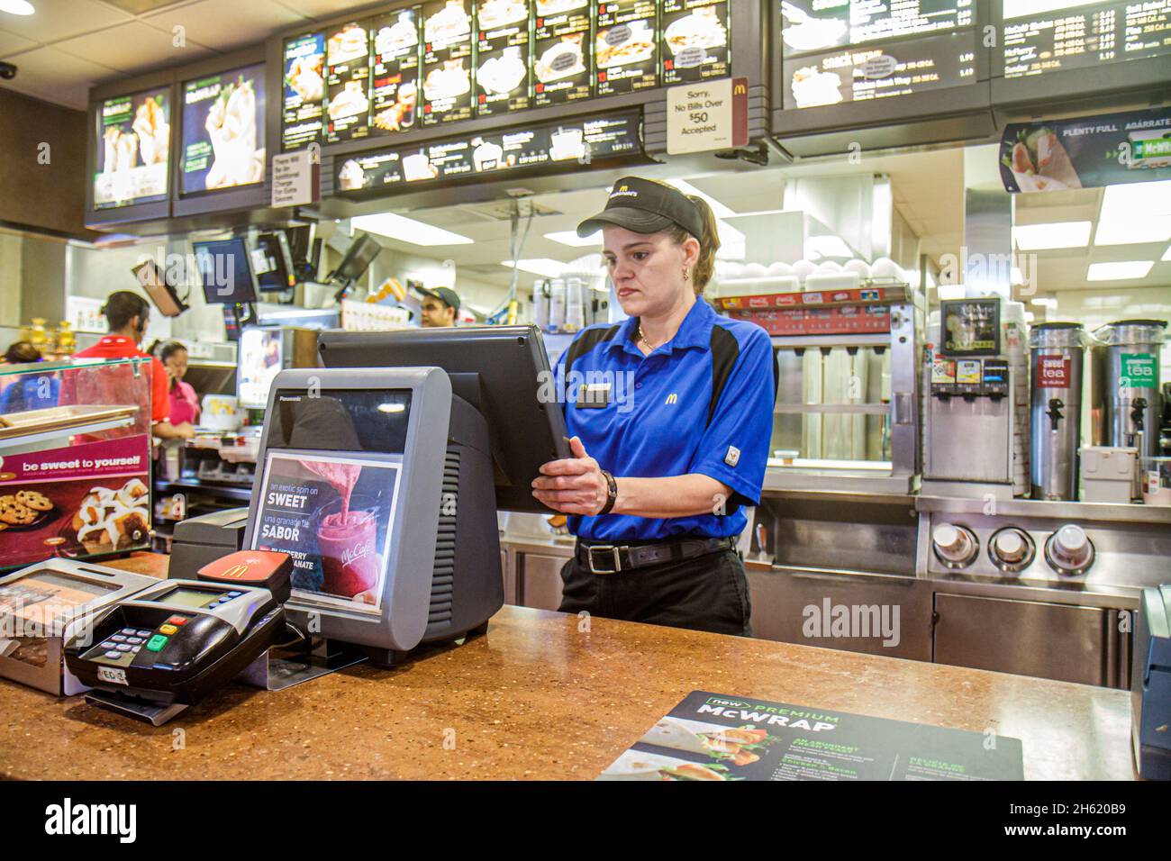 Miami Florida,Homestead,McDonald's fast food restaurant interior inside,counter employee worker working Hispanic woman female cashier Stock Photo