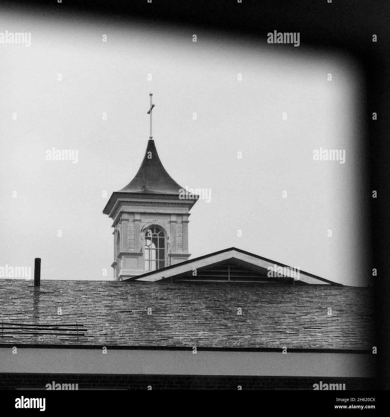 Low angle grayscale shot of a church with a cross on top Stock Photo ...