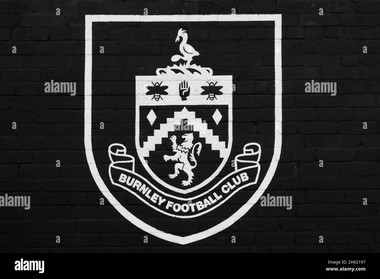Burnley FC badge painted white on black wall, Burnley Stock Photo