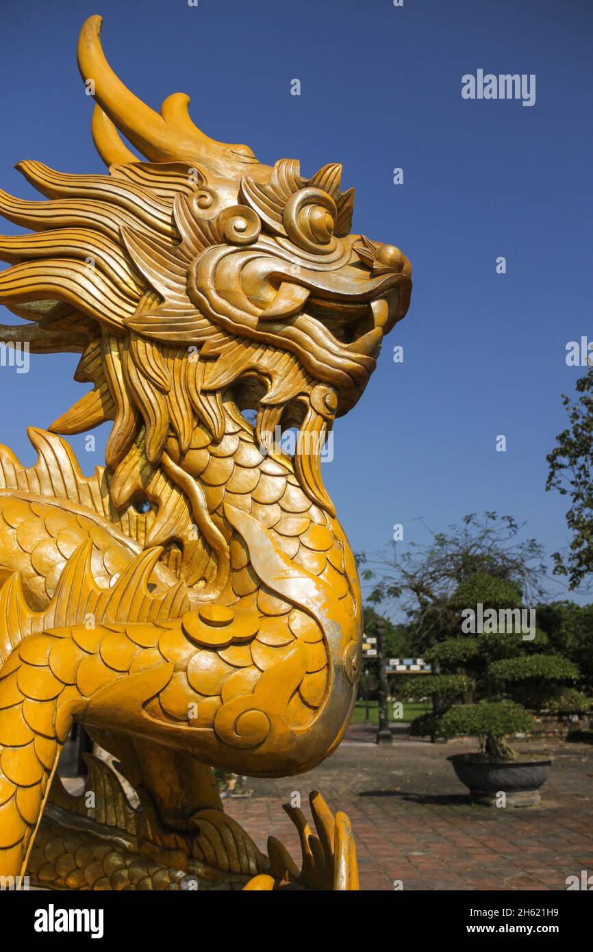 Golden Dragon statue in park outdoors on sunny day in Hue city, Vietnam
