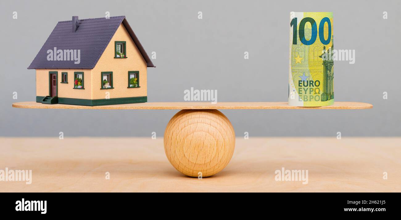 real estate and finances in balance on the seesaw Stock Photo
