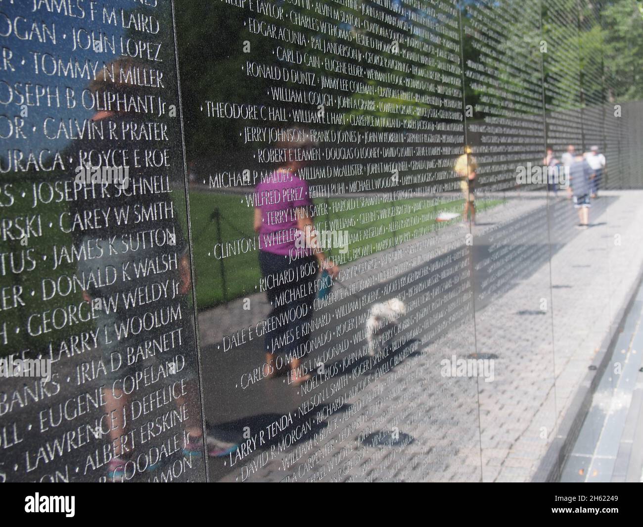 Reflections of visitors in the Vietnam Memorial Wall, Washington, D.C., USA, 2021 © Katharine Andriotis Stock Photo
