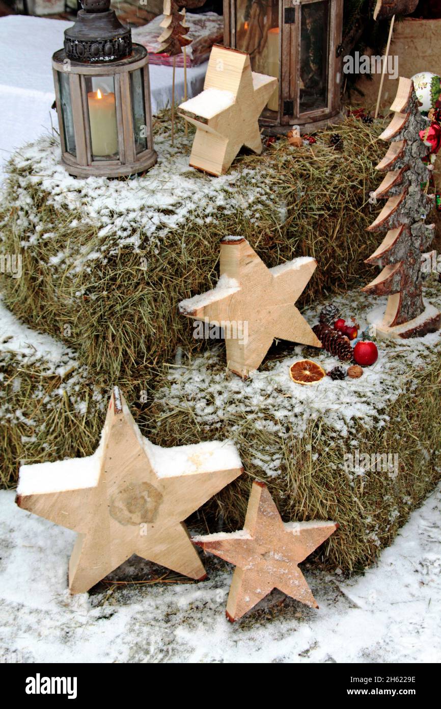 christmas decoration with candle and wooden stars outdoors,covered with snow Stock Photo